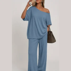 Woman wearing a relaxed-fit Women's 2 Piece Lounge Set with a loose short-sleeve top and wide-leg pants, styled with casual sneakers and a handbag for a comfortable everyday outfit.