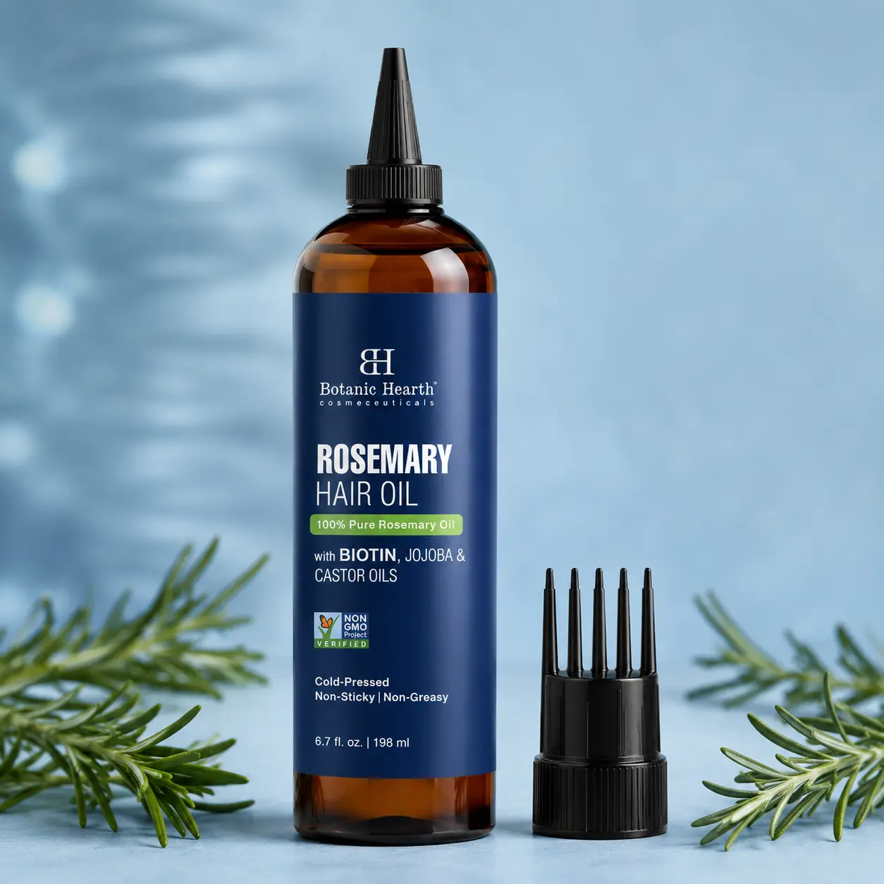 Hair growth oil bottle with comb applicator and fresh rosemary in a clean professional studio product photo.